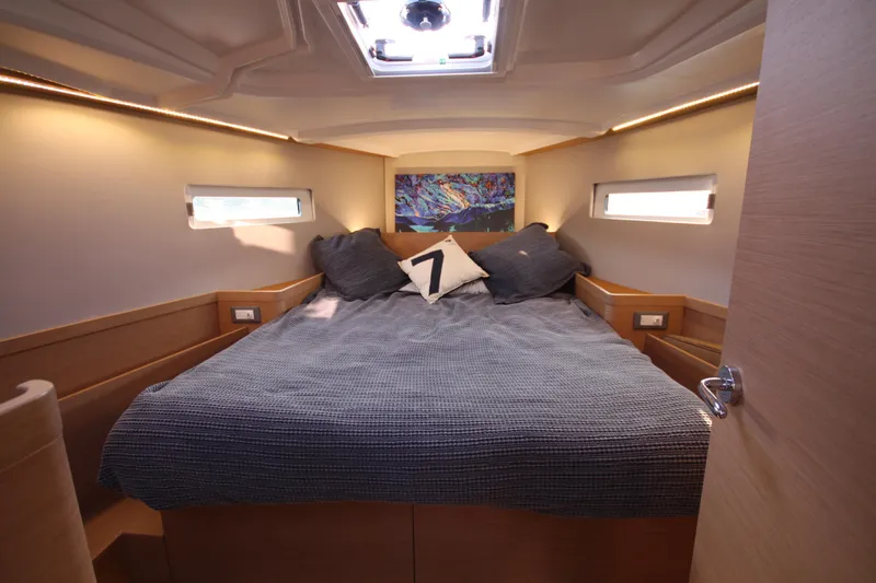 Slide: The Image of Cozy cabin interior of 2022 Jeanneau Sun Odyssey 410 sailboat with double bed. - 17