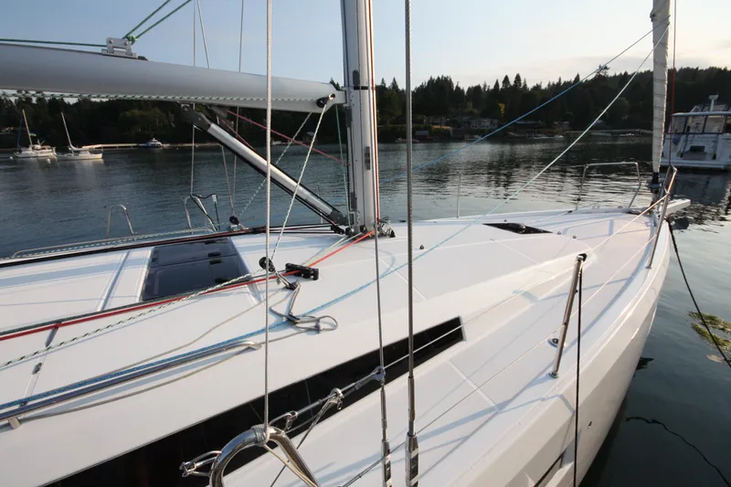 Slide: The Image of 2022 Jeanneau Sun Odyssey 410 sailboat docked in serene waters. - 2