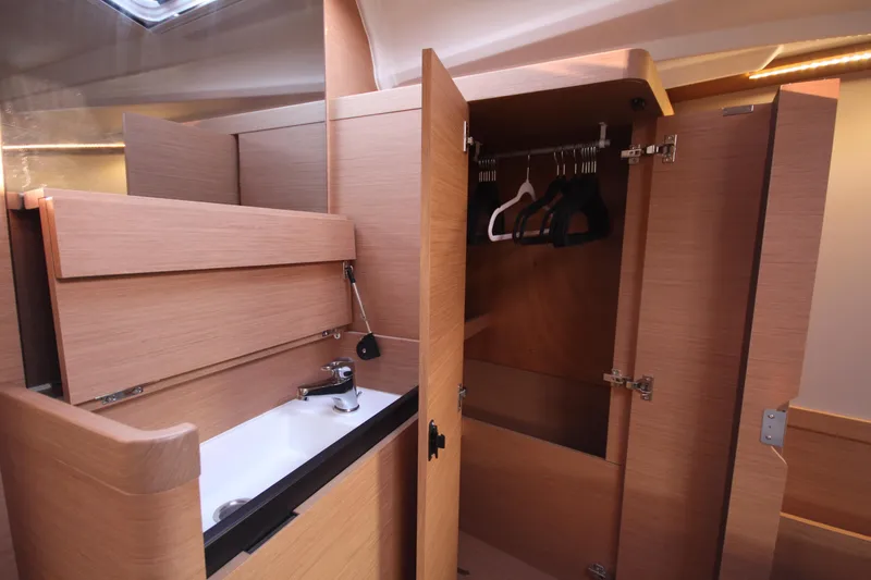 Slide: The Image of Interior of 2022 Jeanneau Sun Odyssey 410 yacht with wooden cabinetry and sink. - 20