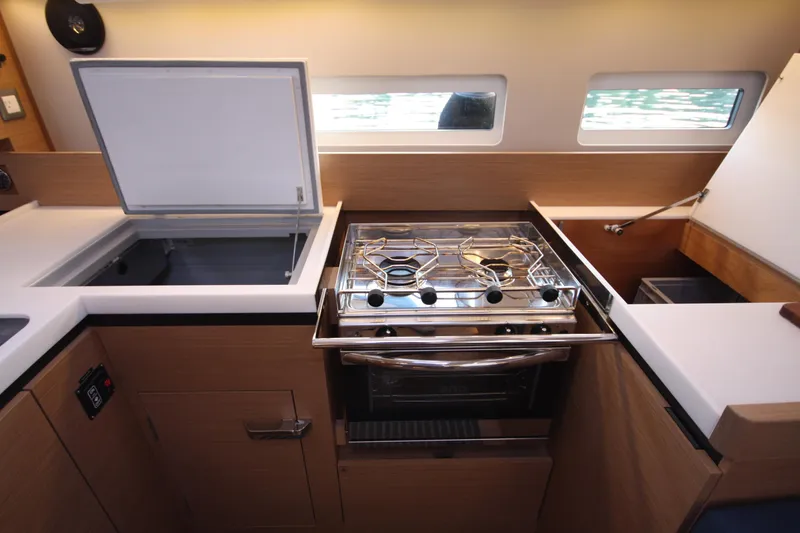 Slide: The Image of Modern kitchen in 2022 Jeanneau Sun Odyssey 410 yacht with stove and storage. - 23