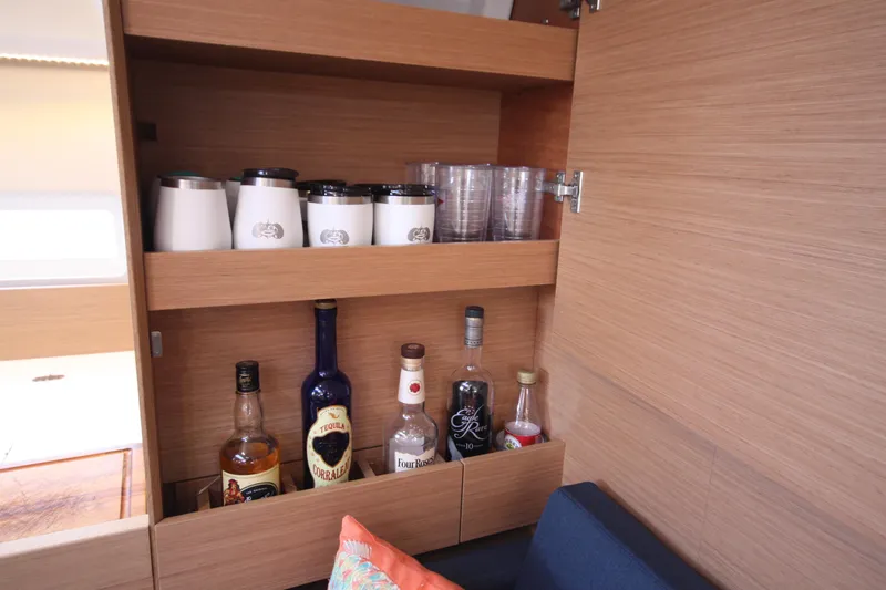 Slide: The Image of Bar cabinet in Jeanneau Sun Odyssey 410 yacht, featuring bottles and cups, 2022 model. - 25