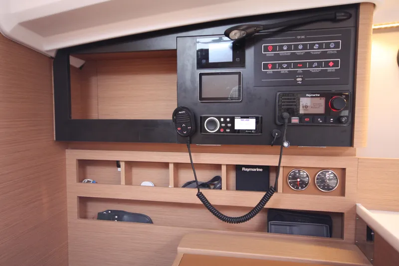 Slide: The Image of Control panel of 2022 Jeanneau Sun Odyssey 410 yacht, featuring navigation and communication equipment. - 26