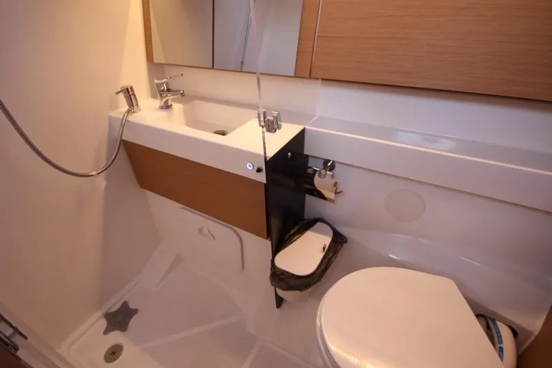 Slide: The Image of Modern bathroom in 2022 Jeanneau Sun Odyssey 410 yacht, featuring sink and toilet. - 27