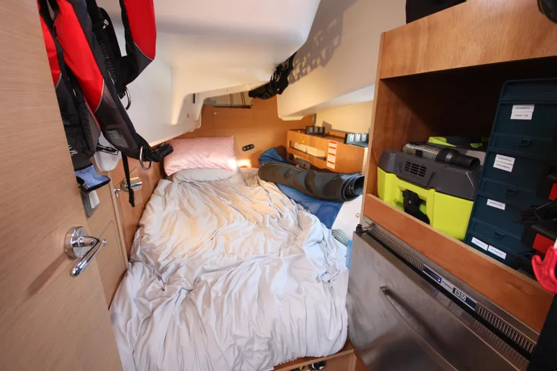 Slide: The Image of Cozy cabin interior of 2022 Jeanneau Sun Odyssey 410 sailboat with bed and storage. - 30