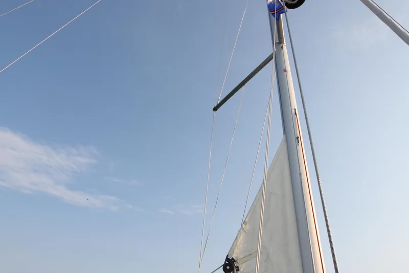 Slide: The Image of Mast and sail of 2022 Jeanneau Sun Odyssey 410 against clear blue sky. - 33