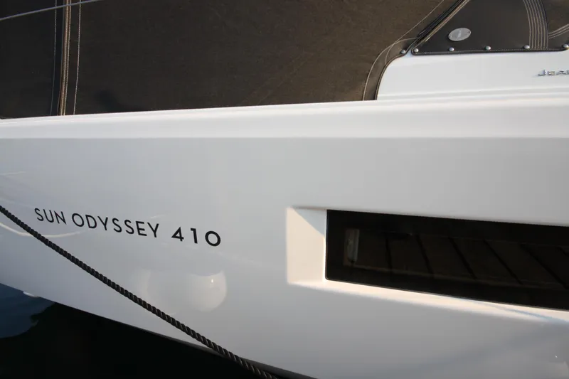 Slide: The Image of 2022 Jeanneau Sun Odyssey 410 yacht, sleek white hull with model name visible. - 34