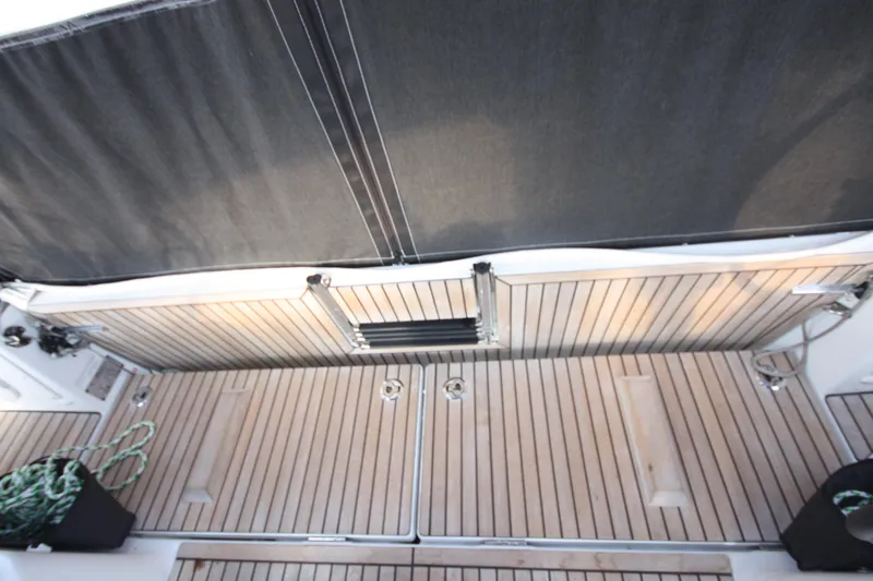 Slide: The Image of 2022 Jeanneau Sun Odyssey 410 yacht deck with teak flooring and black canopy. - 36