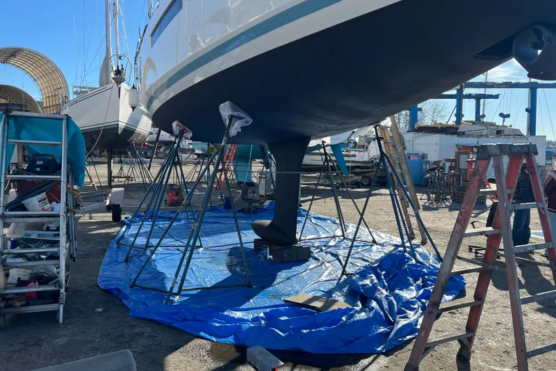 Slide: The Image of 2022 Jeanneau Sun Odyssey 410 sailboat under maintenance in a shipyard. - 41