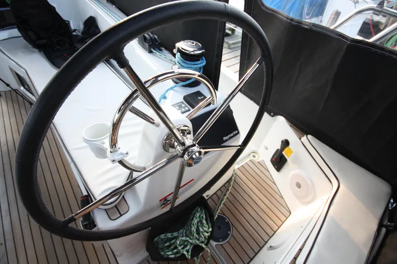 Slide: The Image of Steering wheel of 2022 Jeanneau Sun Odyssey 410 sailboat, featuring modern cockpit design. - 8
