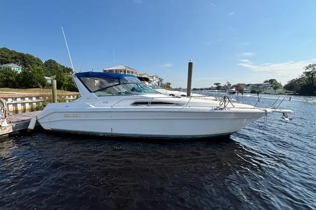 The Image of 1992 Sea Ray 330 Sundancer yacht docked on a sunny day, calm waters. - 1