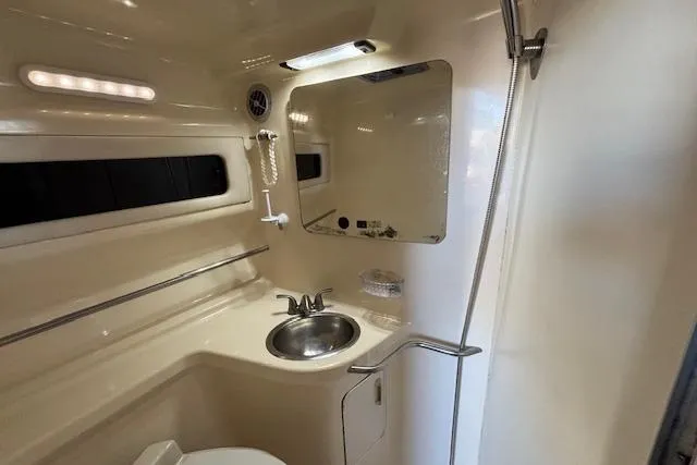 Slide: The Image of 1992 Sea Ray 330 Sundancer bathroom with sink, mirror, and shower. - 13