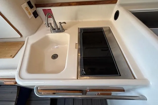 Slide: The Image of 1992 Sea Ray 330 Sundancer kitchen with sink and stovetop. - 14