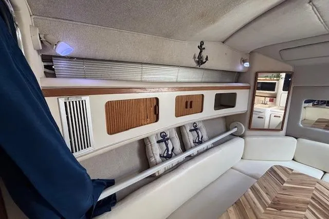 Slide: The Image of Interior of 1992 Sea Ray 330 Sundancer with nautical decor and wood accents. - 16
