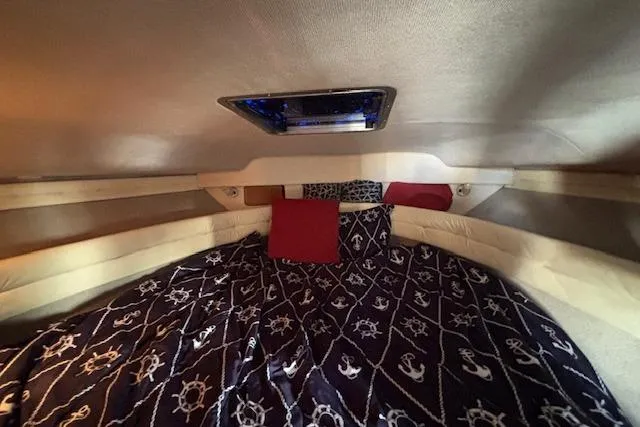 Slide: The Image of Interior cabin of 1992 Sea Ray 330 Sundancer with nautical-themed bedding and skylight. - 18