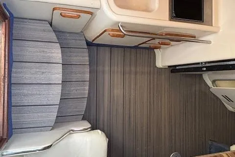 Slide: The Image of 1992 Sea Ray 330 Sundancer cabin interior with seating and kitchenette area. - 20