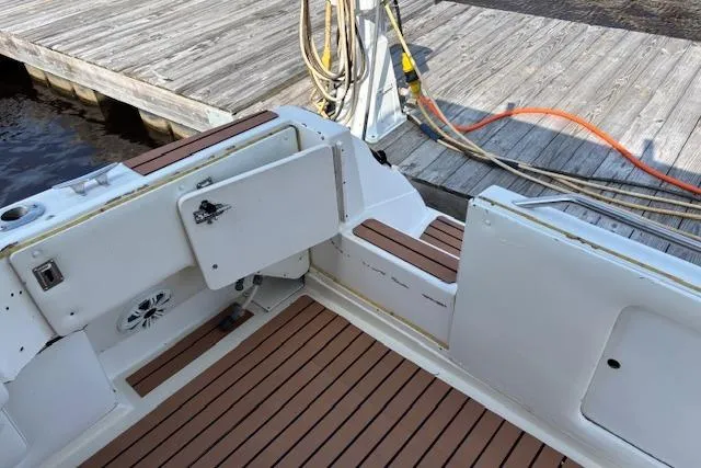 Slide: The Image of 1992 Sea Ray 330 Sundancer boat deck with wood finish and dockside view. - 8