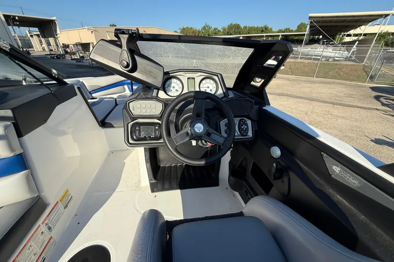 Slide: The Image of 2018 Axis A20 boat cockpit with steering wheel and dashboard controls. - 13
