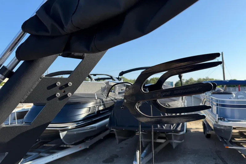 Slide: The Image of 2018 Axis A20 boat with wakeboard rack, docked under clear blue sky. - 19
