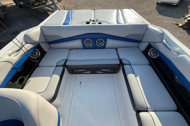 Slide: The Image of Interior of a 2018 Axis A20 boat with cushioned seating and speakers. - 20