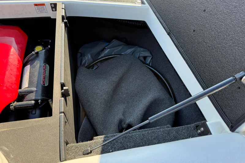 Slide: The Image of 2018 Axis A20 boat storage compartment with equipment and cover. - 23