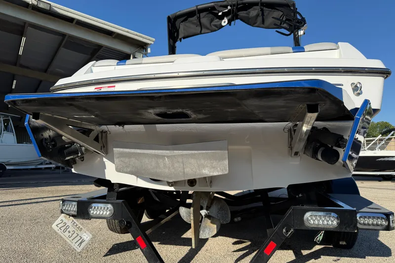 Slide: The Image of 2018 Axis A20 boat on trailer, rear view showing propeller and hull details. - 5