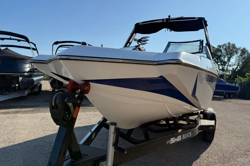 Slide: The Image of 2018 Axis A20 boat on trailer, parked outdoors under clear sky. - 9