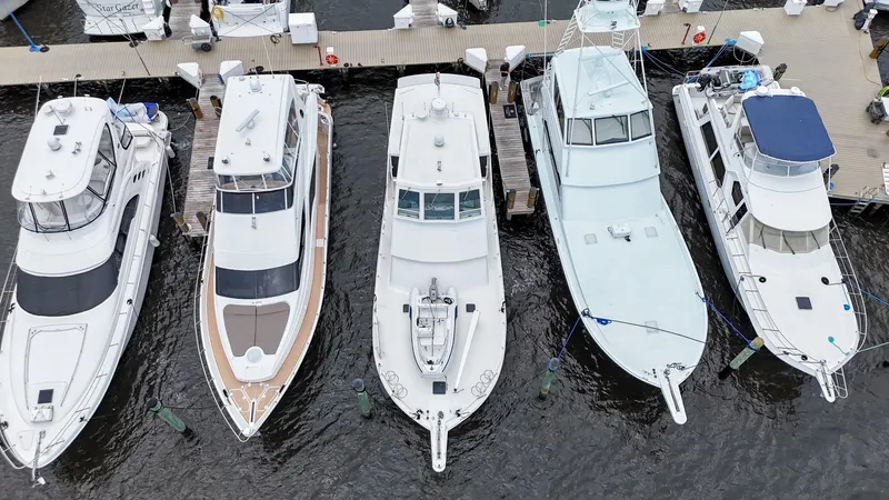 Slide: The Image of Five yachts docked at a marina, including a 1996 Viking 60 Cockpit Sport Yacht. - 10