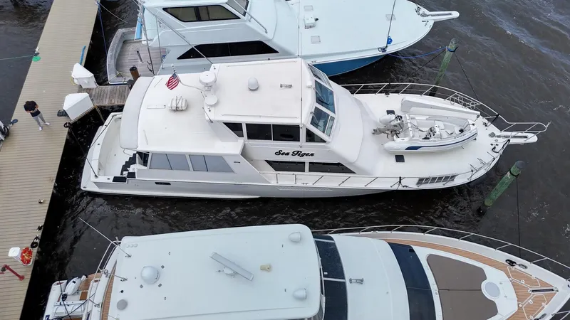 Slide: The Image of 1996 Viking 60 Cockpit Sport Yacht docked at marina, aerial view. - 11