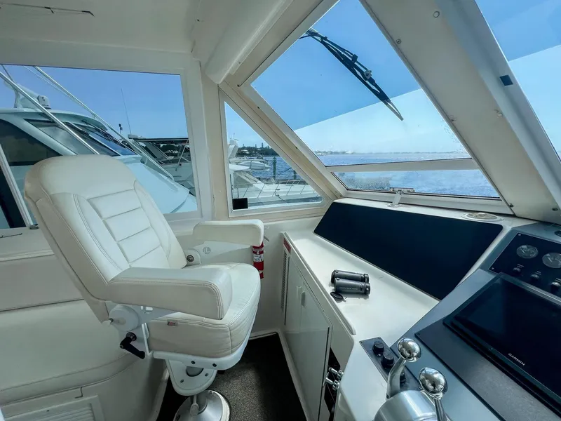 Slide: The Image of 1996 Viking 60 Cockpit Sport Yacht helm with captain's chair and navigation controls. - 16