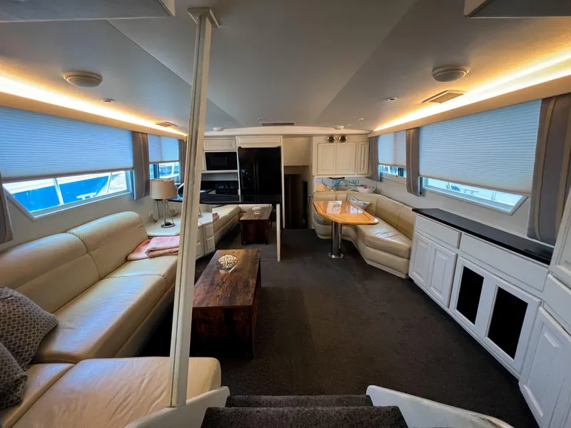 Slide: The Image of Luxurious interior of 1996 Viking 60 Cockpit Sport Yacht with elegant seating and dining area. - 24