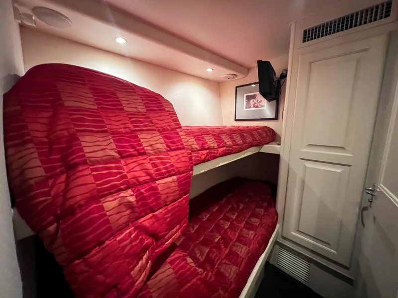 Slide: The Image of Bunk beds with red checkered bedding in a 1996 Viking 60 Cockpit Sport Yacht cabin. - 36