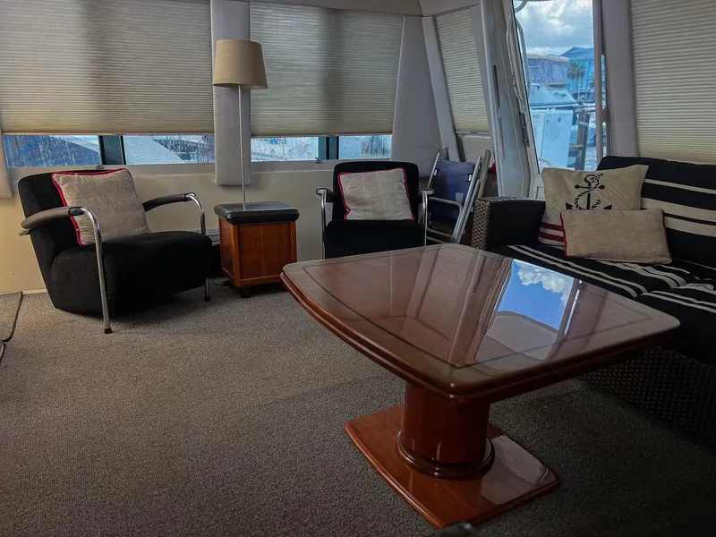 Slide: The Image of Luxurious interior of a 1996 Viking 60 Cockpit Sport Yacht with elegant seating and table. - 38