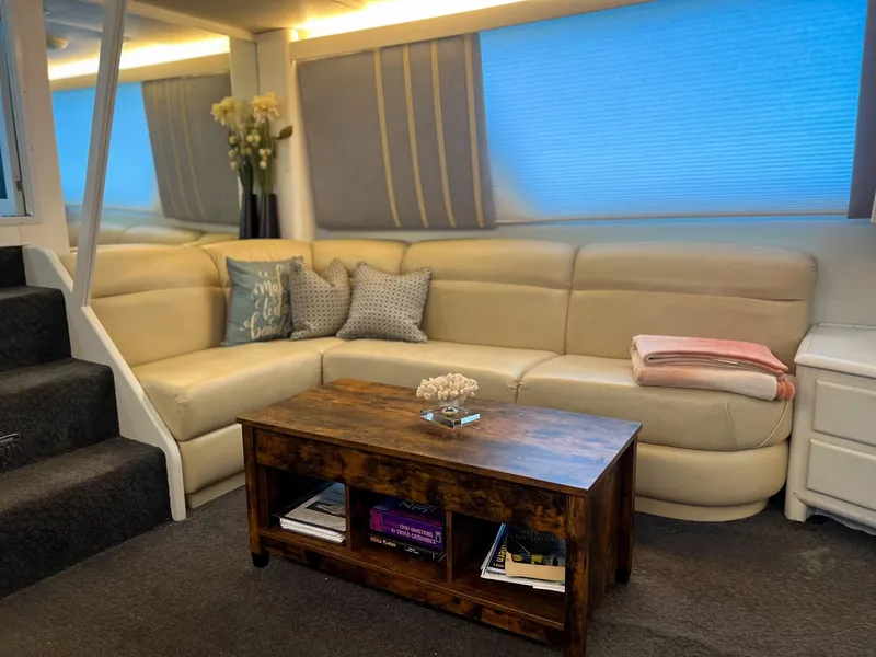 Slide: The Image of Luxurious interior of 1996 Viking 60 Cockpit Sport Yacht with beige sofa and wooden table. - 39