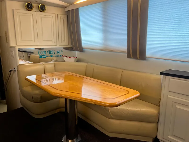Slide: The Image of Interior of 1996 Viking 60 Cockpit Sport Yacht with beige seating and wooden table. - 41