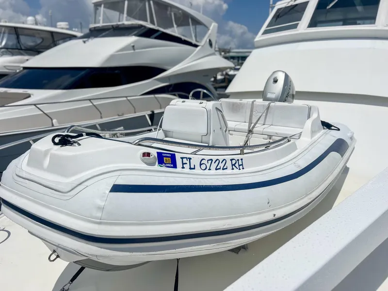 Slide: The Image of Inflatable boat on 1996 Viking 60 Cockpit Sport Yacht, docked with other yachts. - 48