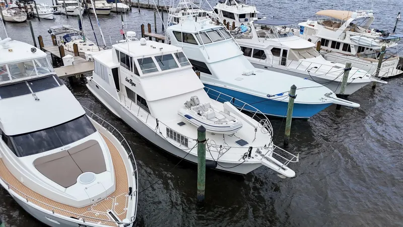 Slide: The Image of Docked yachts including a 1996 Viking 60 Cockpit Sport Yacht at a marina. - 6