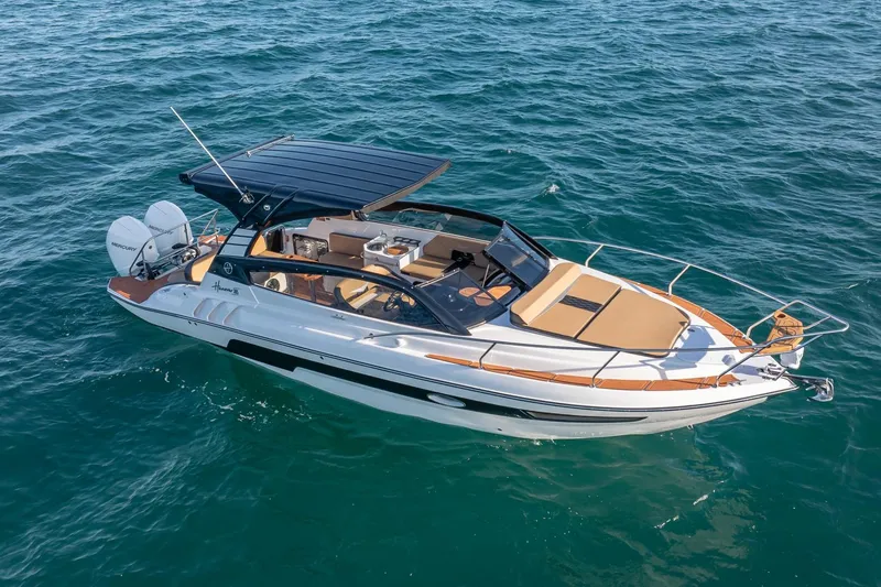 The Image of 2026 Hanover 305 boat cruising on open water, featuring sleek design and modern amenities. - 1
