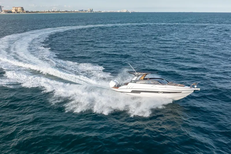 Slide: The Image of 2026 Hanover 305 speedboat cruising swiftly on open ocean waters. - 10