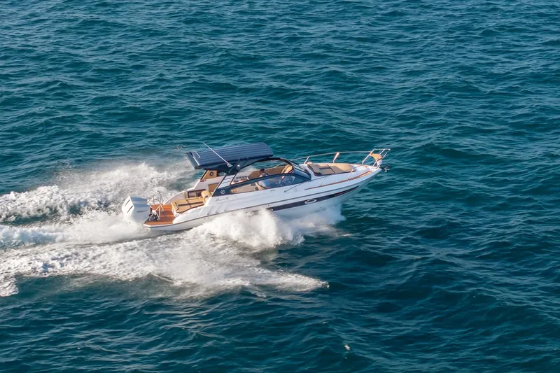 Slide: The Image of 2026 Hanover 305 boat cruising on open sea, creating white water trails. - 11