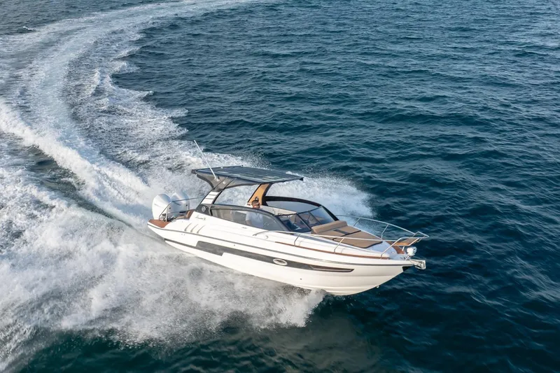 Slide: The Image of 2026 Hanover 305 boat cruising on open water, creating a dynamic wake. - 13