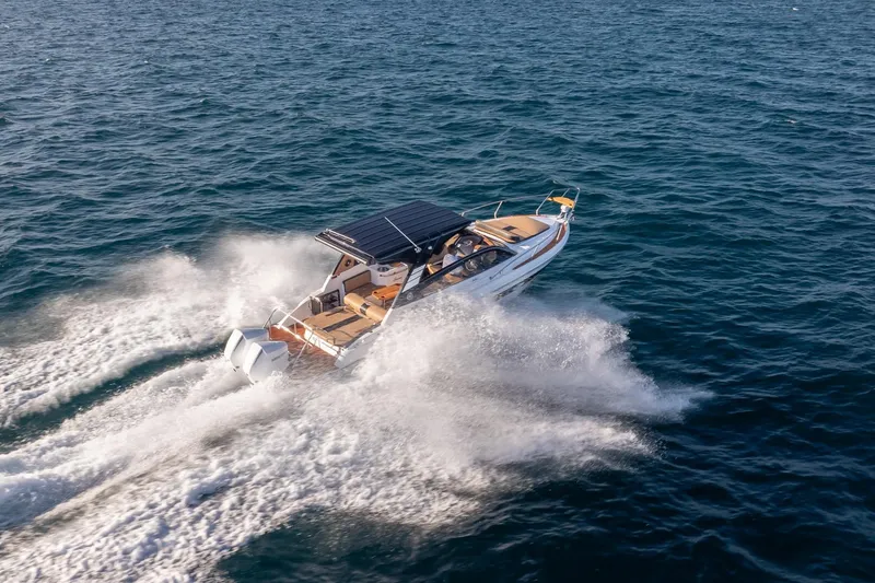 Slide: The Image of 2026 Hanover 305 boat cruising swiftly on open water. - 15