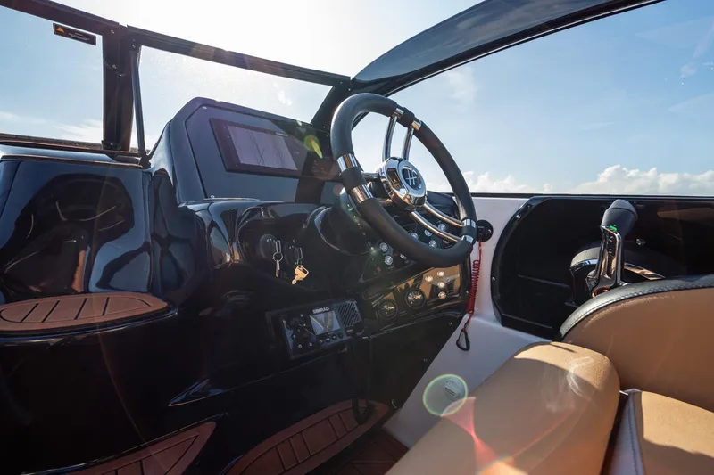 Slide: The Image of Interior view of 2026 Hanover 305 boat cockpit with steering wheel and controls. - 19