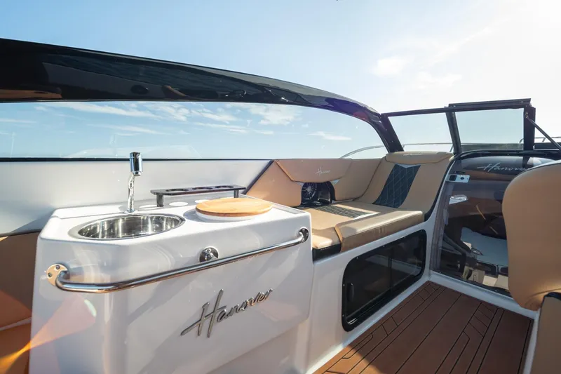 Slide: The Image of Luxurious Hanover 305 boat interior with kitchenette and seating, 2026 model. - 21