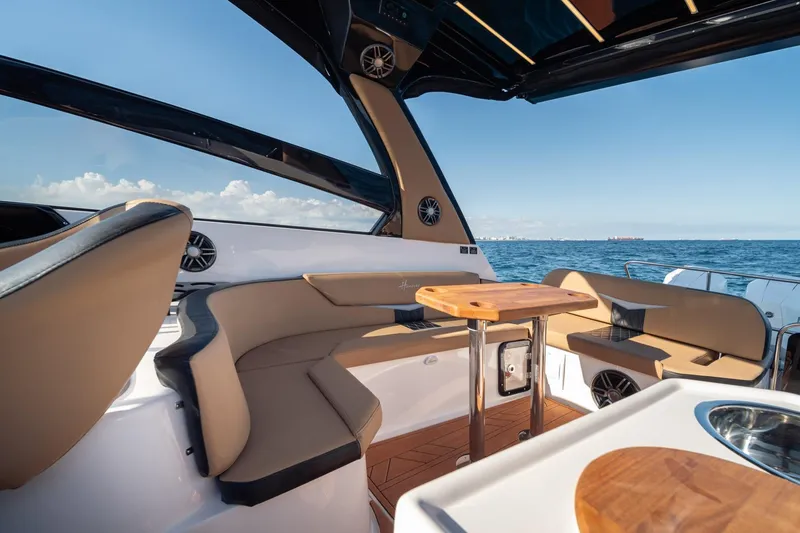 Slide: The Image of Luxurious Hanover 305 yacht interior, featuring elegant seating and ocean view, 2026 model. - 22