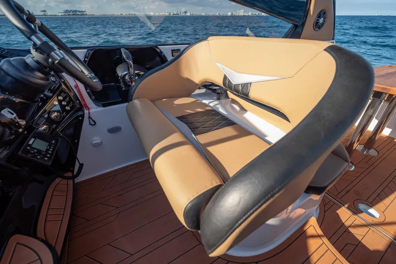 Slide: The Image of Interior of 2026 Hanover 305 boat with tan and black seating, ocean view. - 26