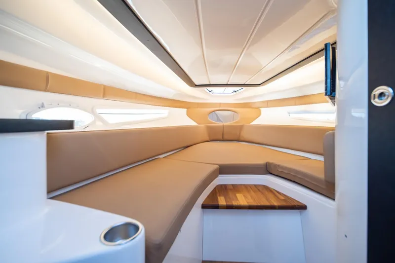 Slide: The Image of Luxurious interior of 2026 Hanover 305 boat with beige seating and wooden accents. - 30