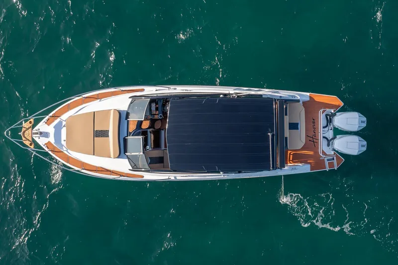 Slide: The Image of Aerial view of 2026 Hanover 305 luxury boat cruising on clear blue water. - 5