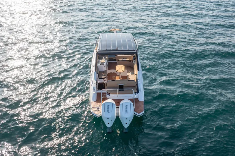 Slide: The Image of Aerial view of 2026 Hanover 305 boat with dual engines on open water. - 7