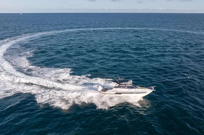 Slide: The Image of Aerial view of Hanover 305 yacht making a circular wake in the ocean, 2026 model. - 9