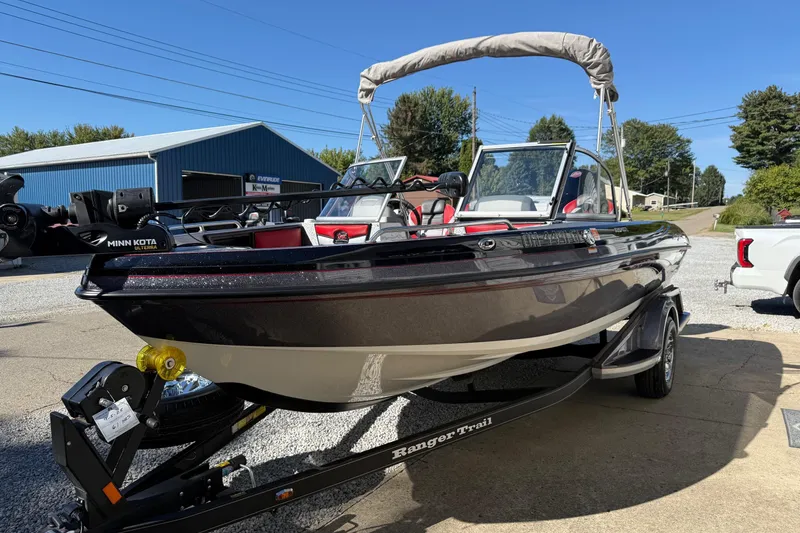 Slide: The Image of 2023 Ranger 1850 Reata boat on trailer, parked outdoors under clear blue sky. - 11